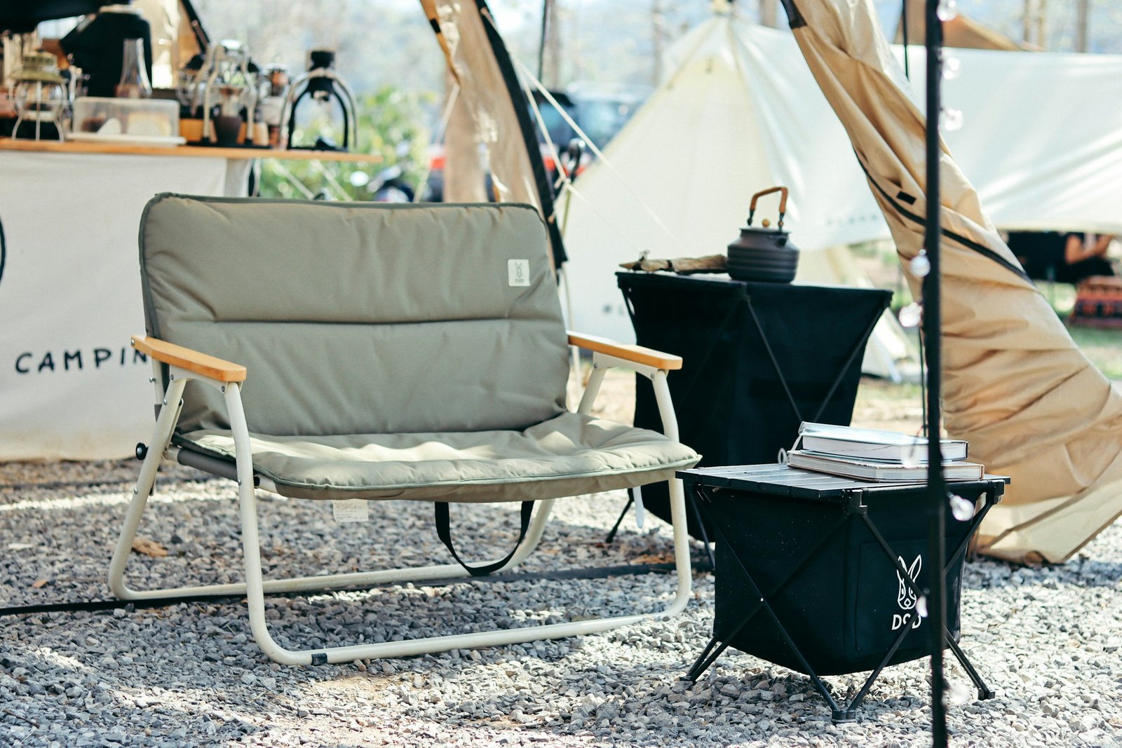 Black and white folding camping chair at a campsite