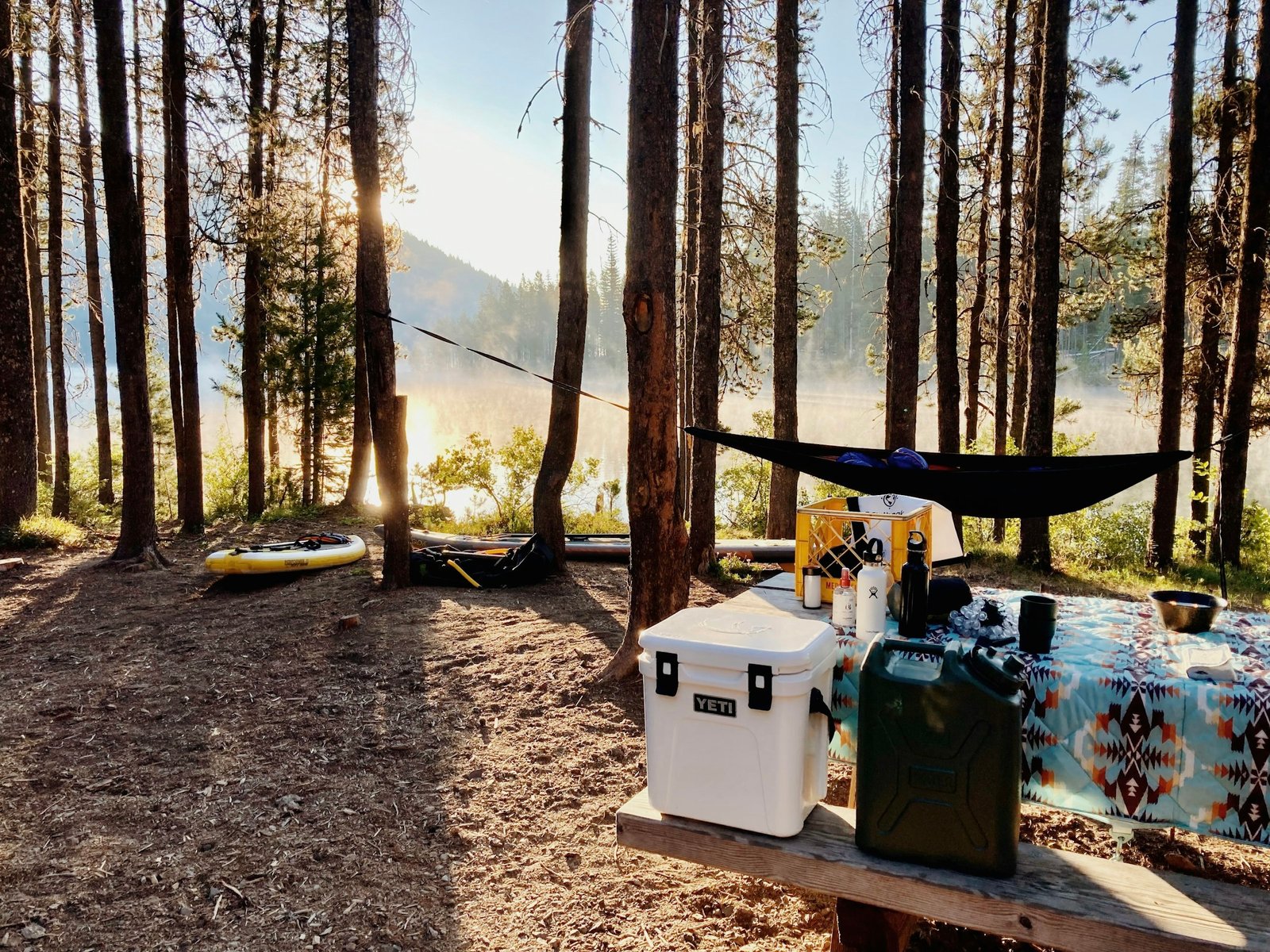 Camping cooler at a scenic Oregon campsite with mountains and lake in the background