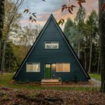 A-frame cabin in the woods, representative of North Rivers Edge Luxury Camping