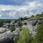 Rocky cliff with trees in Shawnee National Forest, representative of Shawnee Hills Glamping Dome