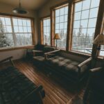 Cozy cabin interior with large windows, representative of The Woods Luxury Camping